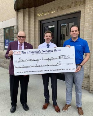three people holding a Lemnitzer scholarship donation for Gavin Anthony Kopesky