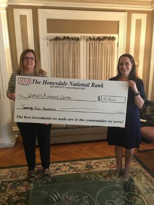 Nancy Perri and Elizabeth Nagy holding check donation for The Women's Resource Center