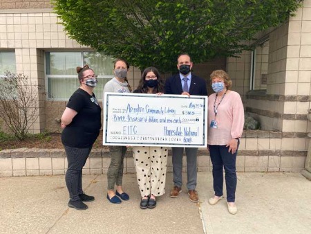 four people holding check donation for Abington Community Library