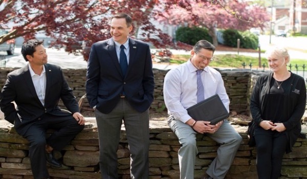 group of consumer lenders sitting on a wall