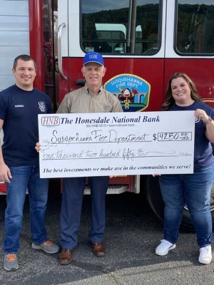 Rick Soden and the Susquehanna Fire Department holding check donation