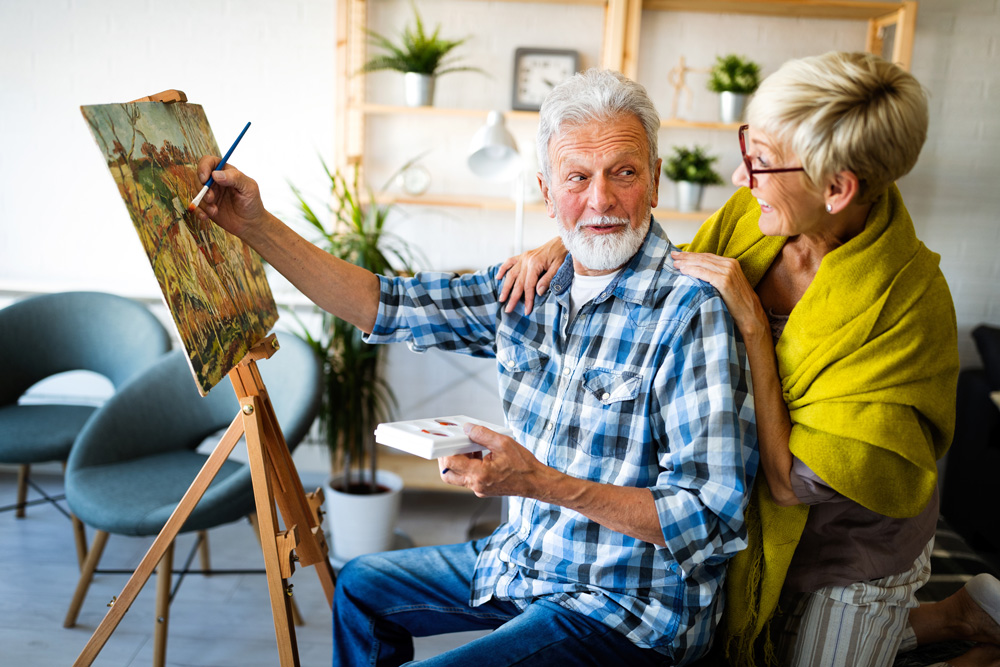 elderly couple painting