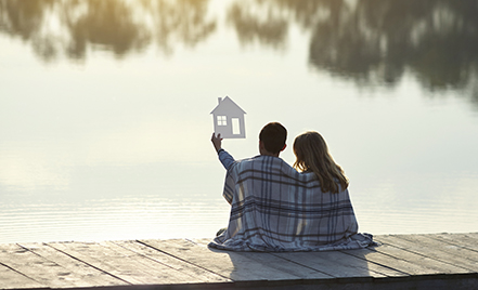 couple sitting on dock on a lake