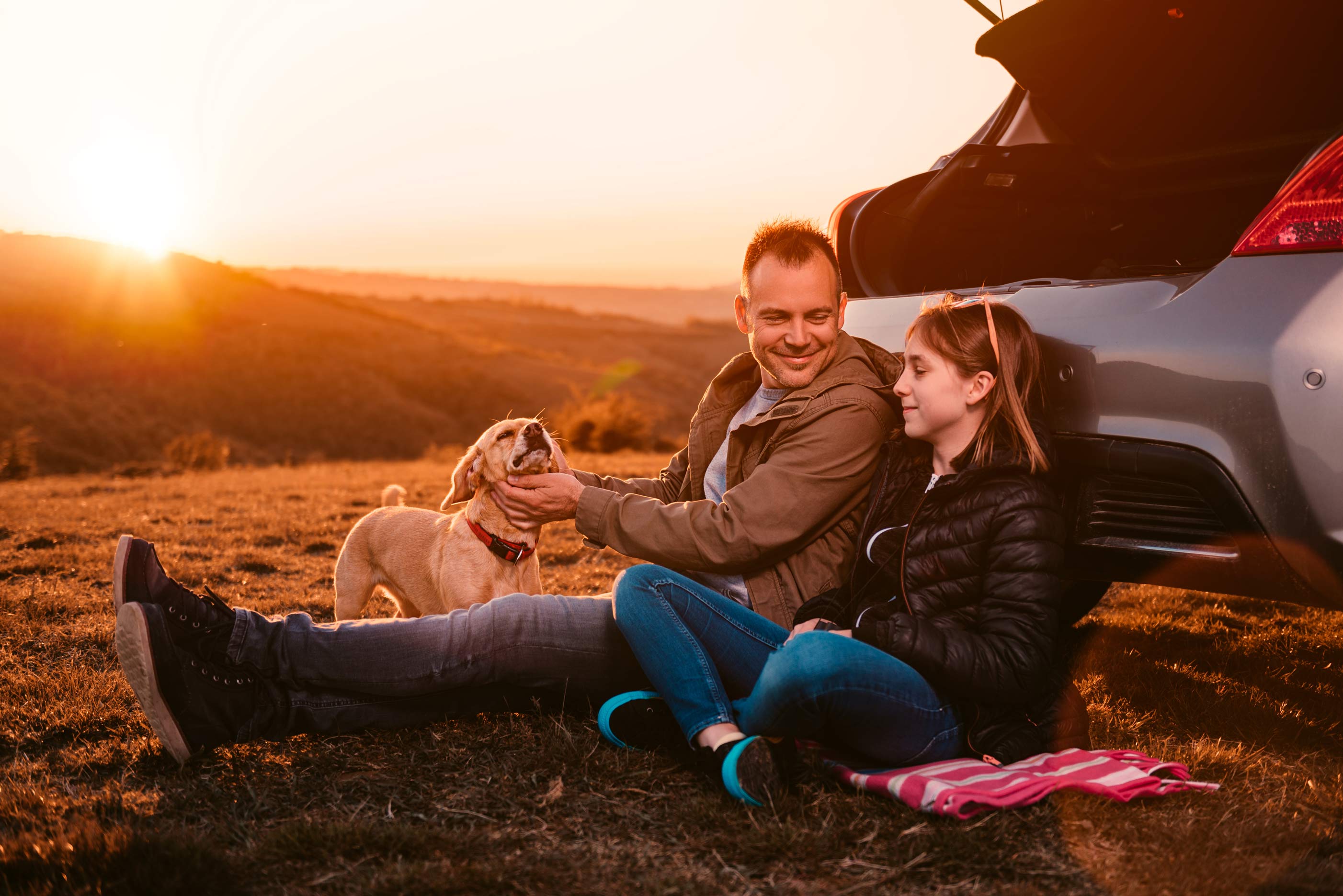 father and daughter outside on ground