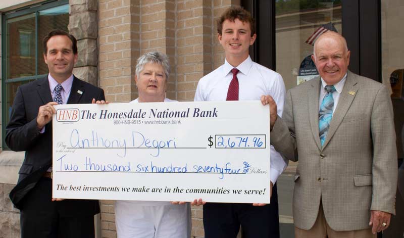 Anthony Degori accepts large check