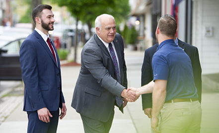 group shaking hand of new employee