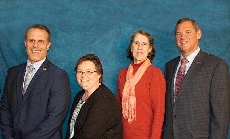 Three 15 year honorees standing by the President