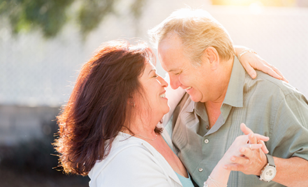 middle-aged couple dancing outside