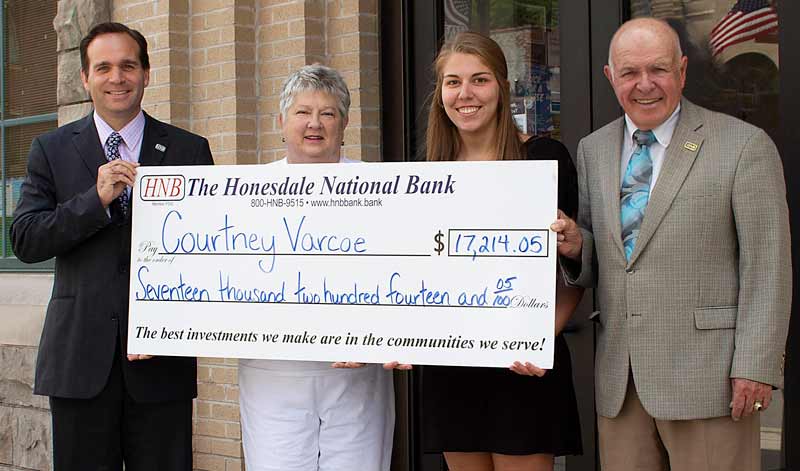 Courtney Varcoe accepts large check