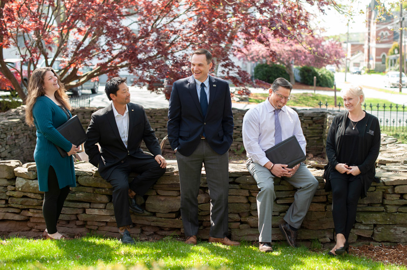 group of consumer lenders sitting on a wall