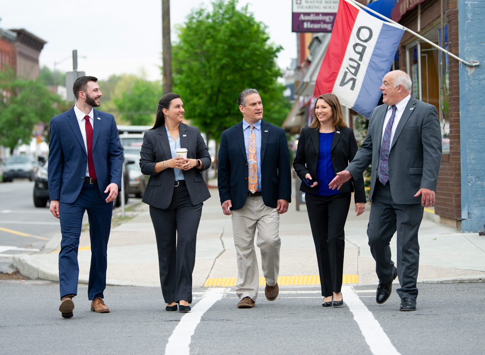 commercial lenders group walking down Main Street